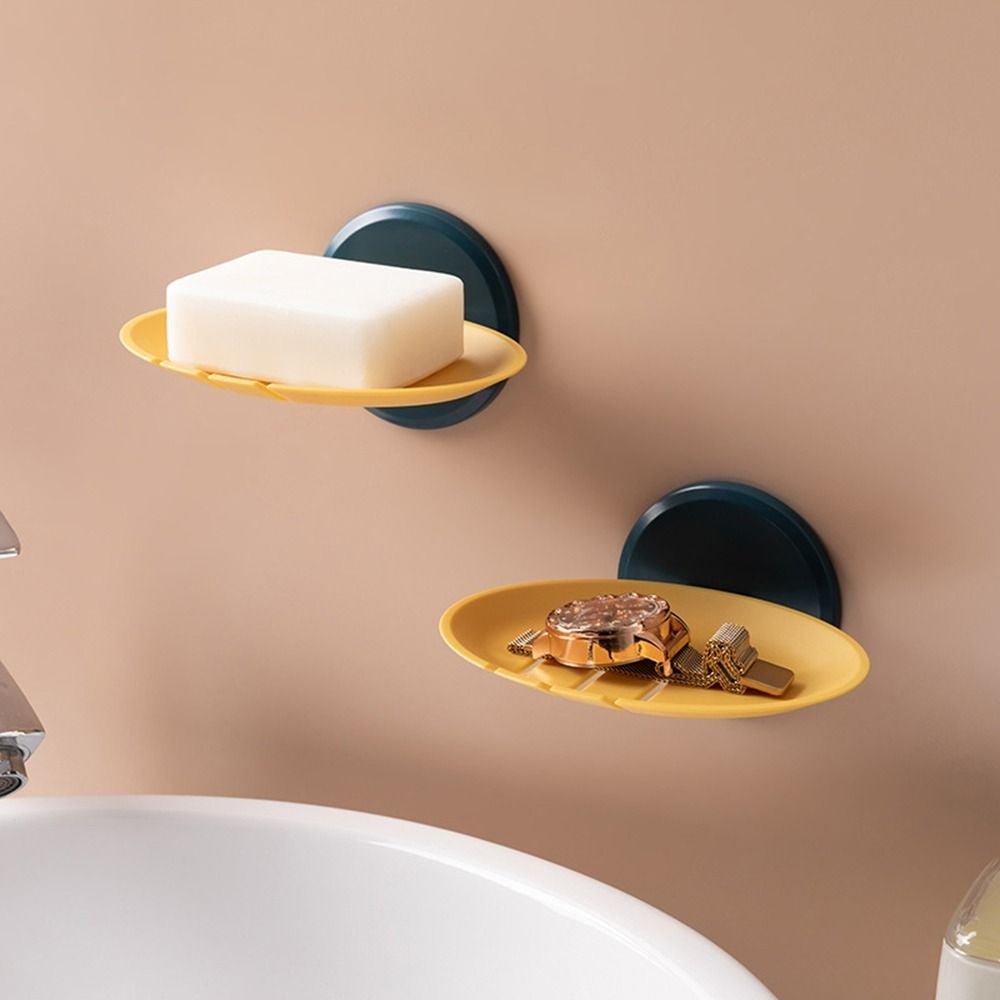 porte savon mural en forme de feuille jaune avec montre posée dessus