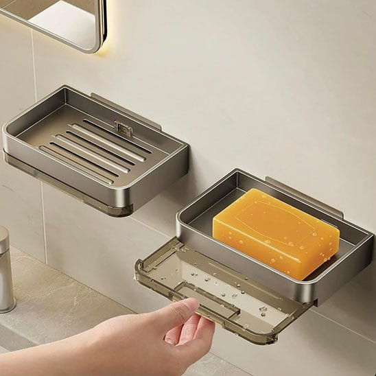 Metal soap dish with a bar of soap on a bathroom counter